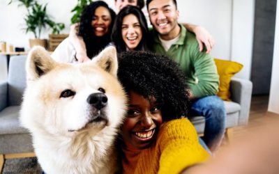 Happy family taking a selfie with their dog, showcasing trust and care in a cozy home environment.